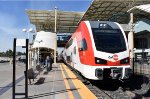 A southbound early afternoon Caltrain arrives into the station with Stadler KISS MU Car # 310 in the lead